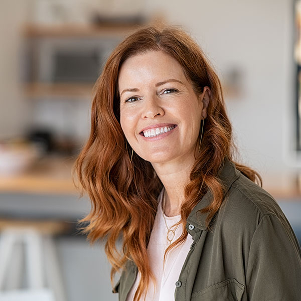 Woman with Red Hair Smiling Indoors